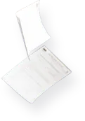 A white sheet of paper rests on a smooth black surface, creating a stark contrast between the two colors.